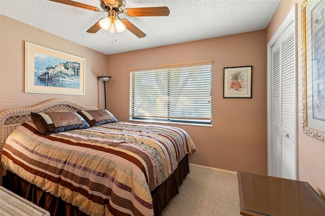 bedroom featuring light carpet, a textured ceiling, a closet, and ceiling fan