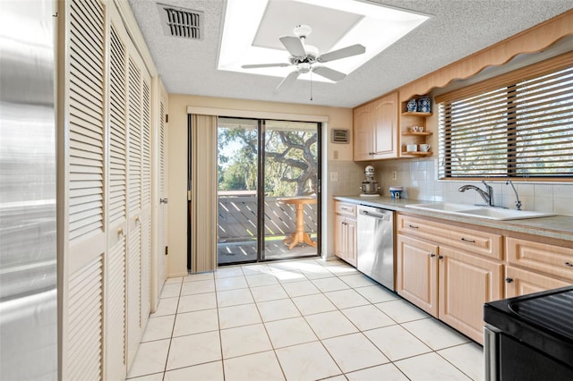 kitchen with decorative backsplash, light tile patterned floors, a textured ceiling, and stainless steel dishwasher