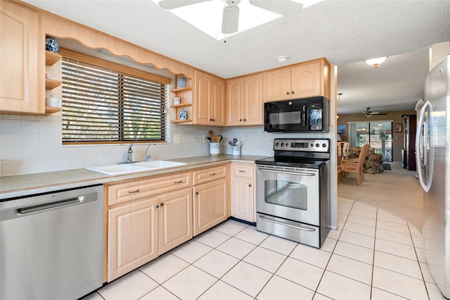 kitchen featuring light brown cabinets, sink, ceiling fan, light tile patterned floors, and stainless steel appliances