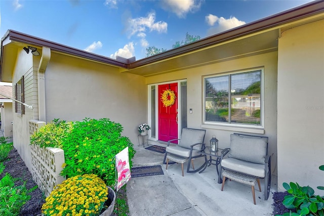 view of exterior entry with a patio