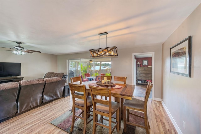 dining space featuring light wood-type flooring and ceiling fan