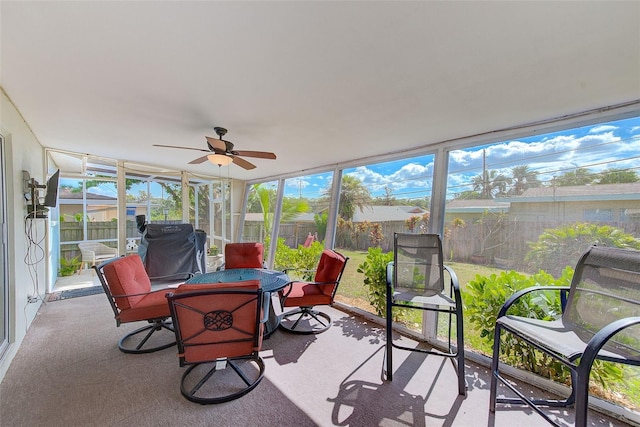 sunroom featuring ceiling fan