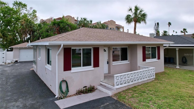 3505 Casablanca Ave, St Pete Beach, FL 33706 - ranch-style house featuring stucco siding, a detached garage, and a shingled roof