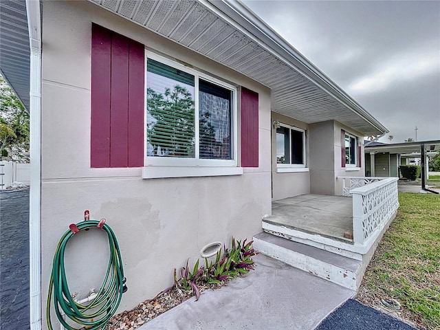 3505 Casablanca Ave, St Pete Beach, FL 33706 - entrance to property featuring covered porch and stucco siding