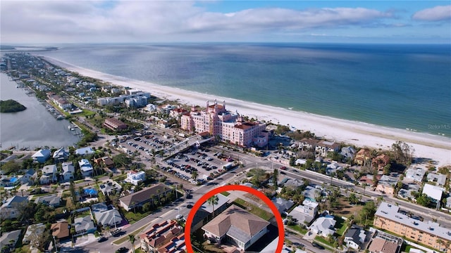 birds eye view of property featuring a beach view and a water view