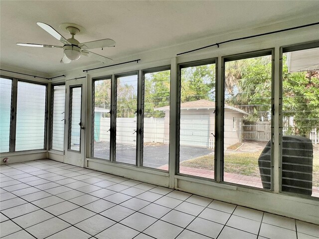3505 Casablanca Ave, St Pete Beach, FL 33706 - unfurnished sunroom with a ceiling fan and tile patterned floors