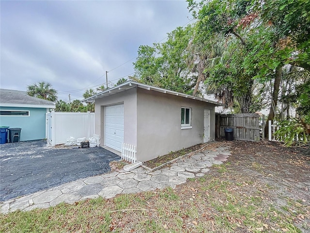 view of side of home with an outbuilding and a garage