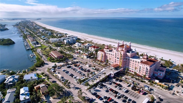 birds eye view of property with a water view and a view of the beach