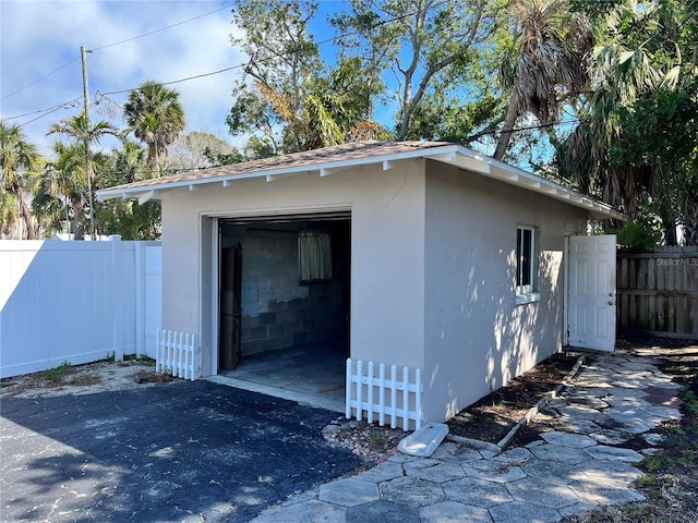 detached garage featuring fence