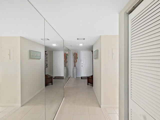 corridor with light tile patterned floors