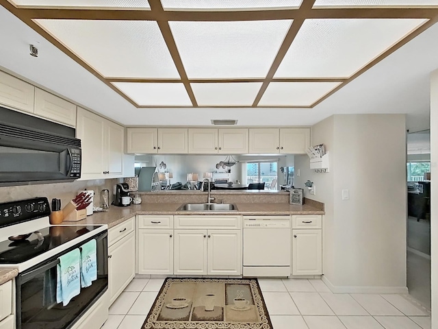 kitchen with light tile patterned flooring, white appliances, kitchen peninsula, and sink