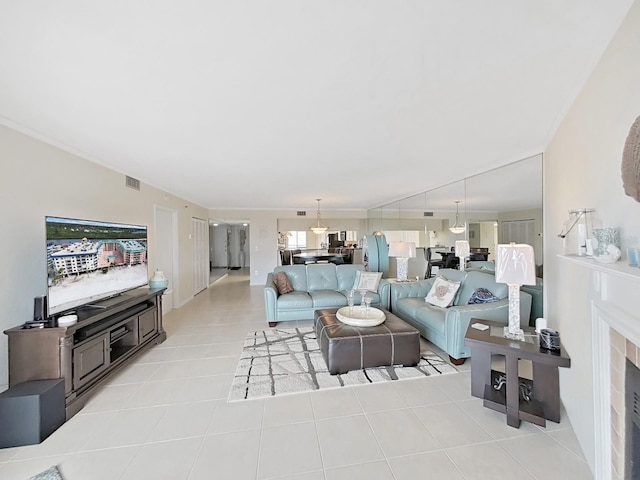 living room featuring light tile patterned floors and ornamental molding