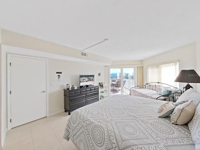 bedroom with light tile patterned floors and access to outside