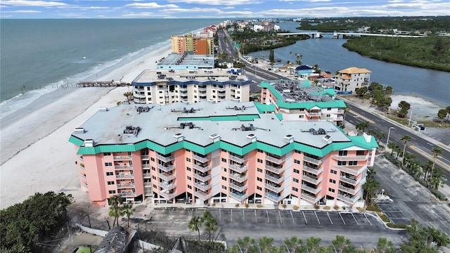 drone / aerial view with a water view and a beach view