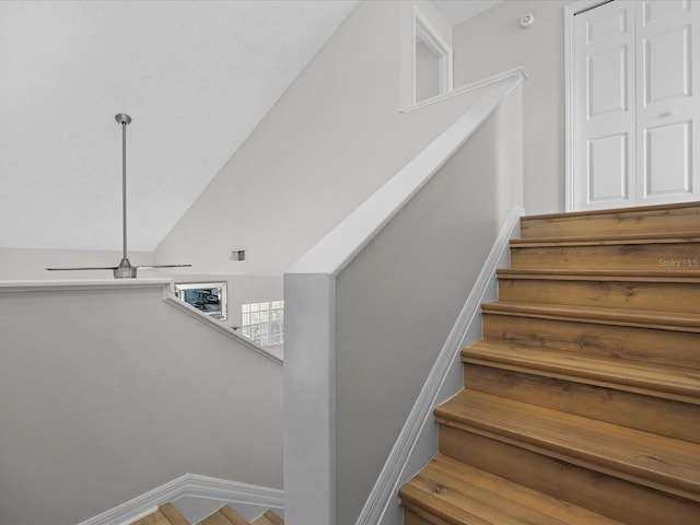 staircase with lofted ceiling