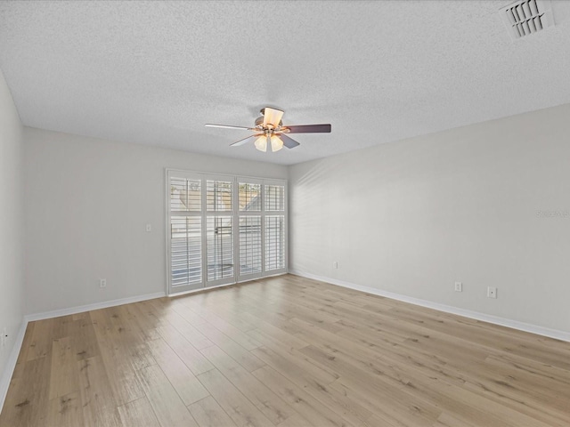 unfurnished room with ceiling fan, light hardwood / wood-style floors, and a textured ceiling