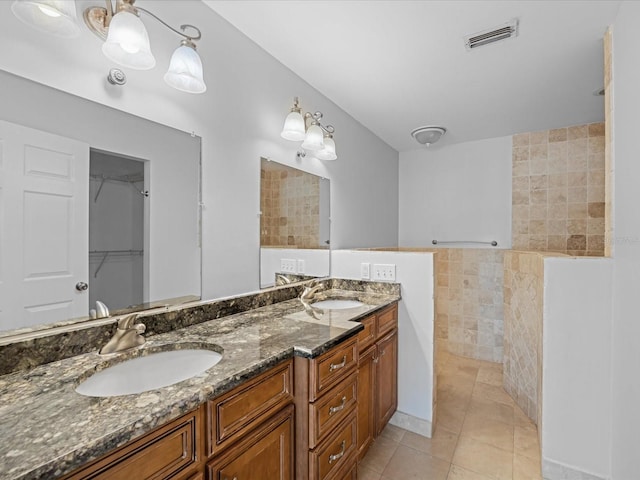 bathroom featuring vanity, tile patterned floors, and tile walls