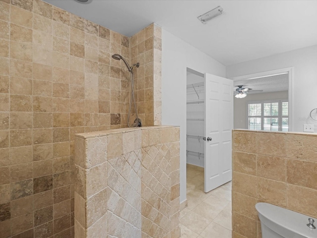 bathroom featuring a tile shower, ceiling fan, tile walls, tile patterned flooring, and toilet