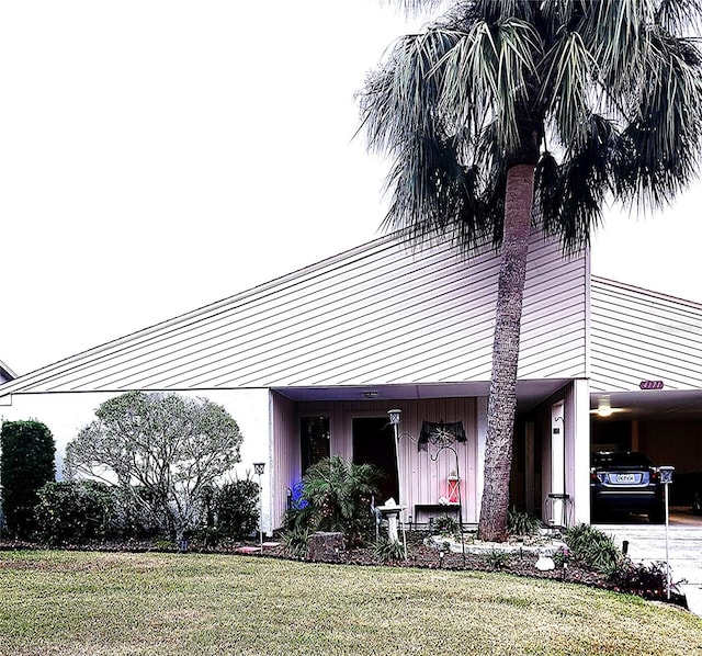 view of front of property with a front lawn and a carport