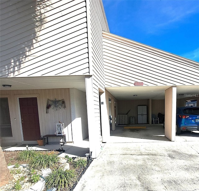 view of property exterior with a carport