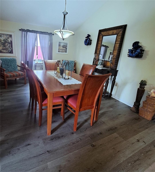 dining space featuring lofted ceiling and dark hardwood / wood-style flooring