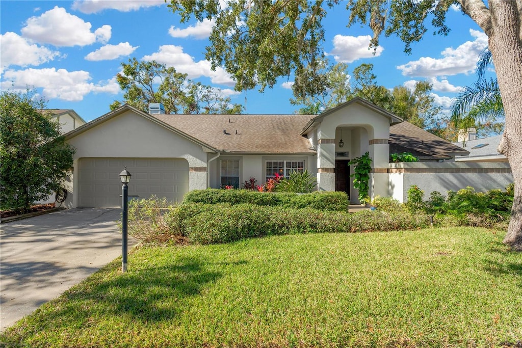 ranch-style home with a front yard and a garage