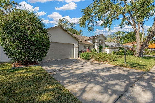 view of front of property with a garage and a front lawn