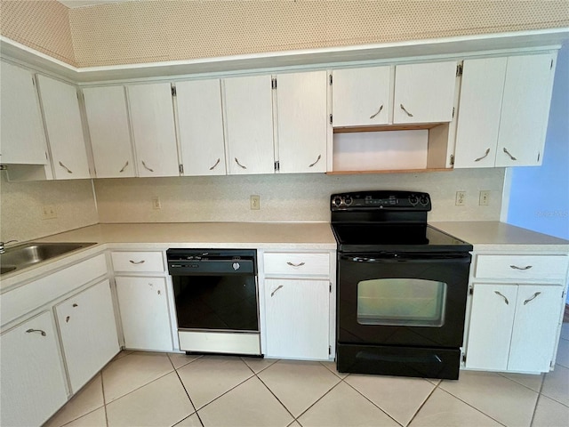 kitchen with black appliances, white cabinetry, and sink