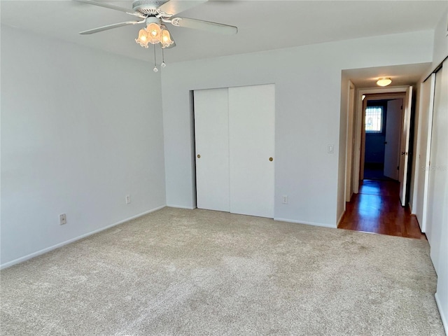 unfurnished bedroom with ceiling fan, dark hardwood / wood-style flooring, and a closet