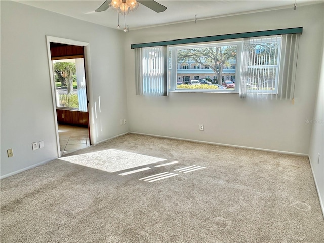 carpeted empty room featuring ceiling fan