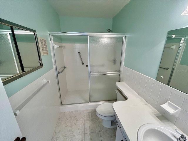 bathroom with tasteful backsplash, tile patterned floors, toilet, a shower with door, and vanity