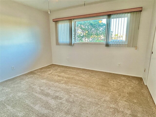 empty room featuring light carpet