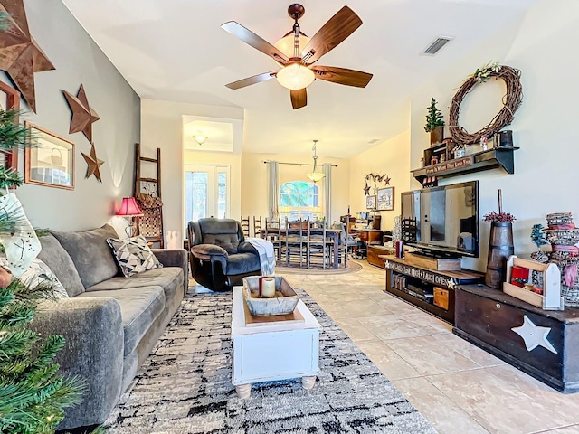 tiled living room with ceiling fan