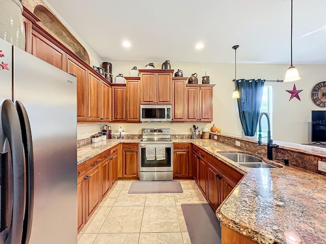 kitchen featuring stone counters, sink, decorative light fixtures, light tile patterned flooring, and stainless steel appliances