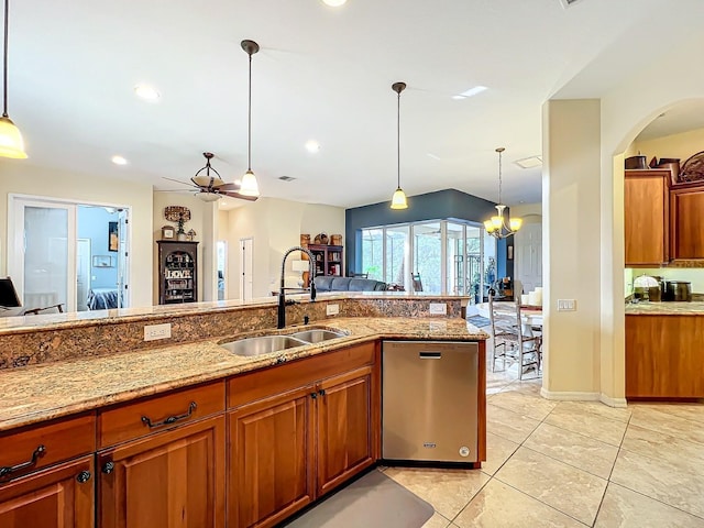 kitchen featuring dishwasher, pendant lighting, ceiling fan with notable chandelier, and sink