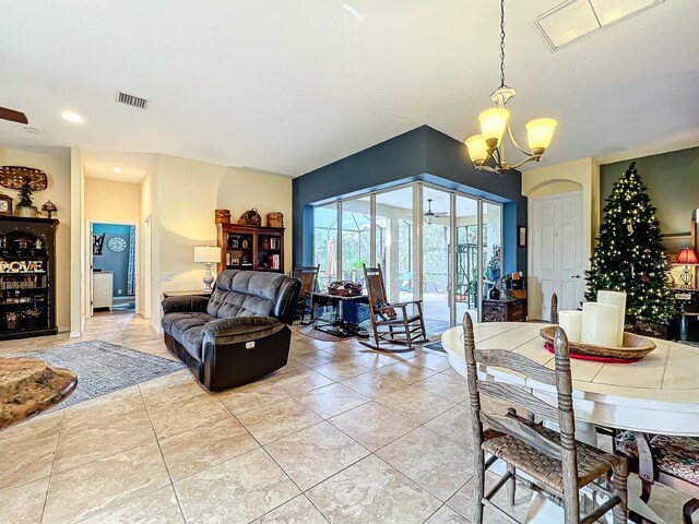 living room featuring a chandelier and light tile patterned floors