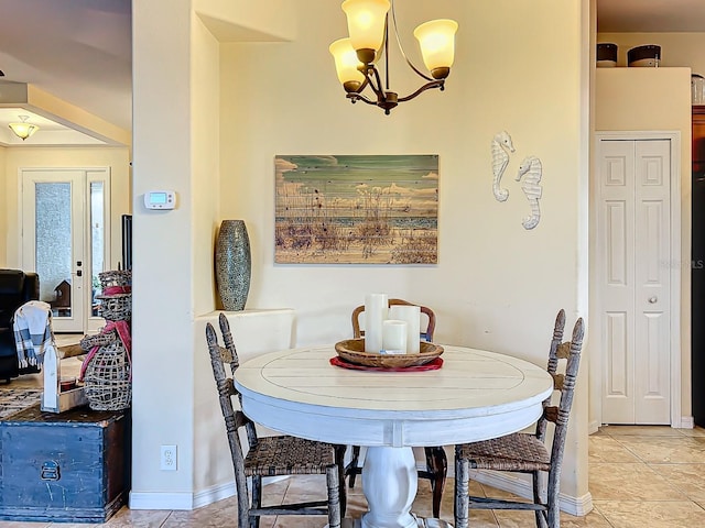 dining space with light tile patterned flooring and an inviting chandelier