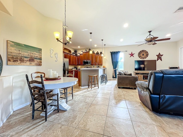 dining room with ceiling fan with notable chandelier