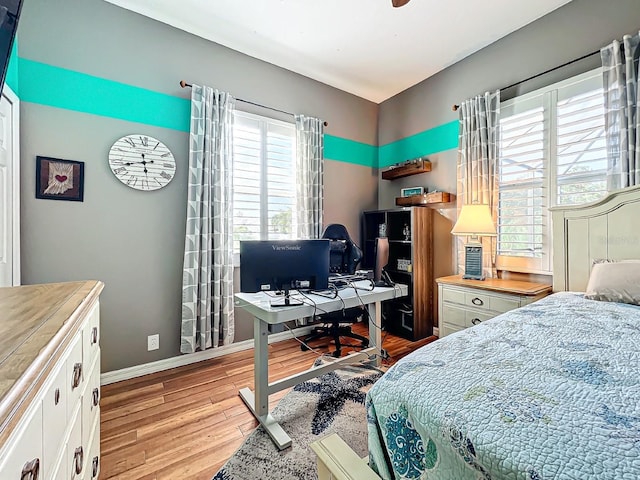 bedroom with ceiling fan and light wood-type flooring