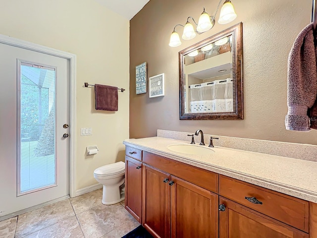 bathroom with tile patterned floors, vanity, toilet, and walk in shower