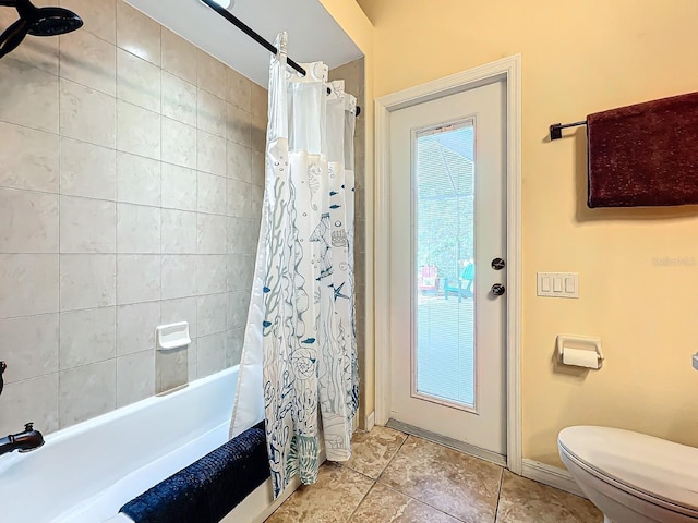 bathroom with shower / bath combo and toilet