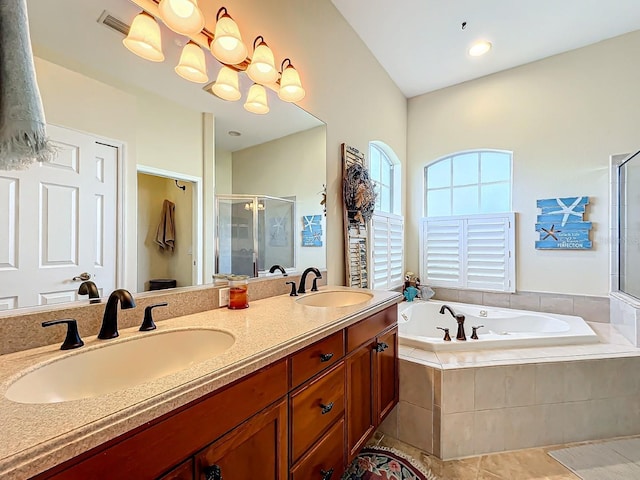 bathroom with tile patterned flooring, vanity, independent shower and bath, and a notable chandelier