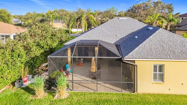 back of house featuring a lanai and a patio area