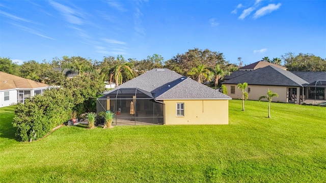 back of house with a lanai and a yard