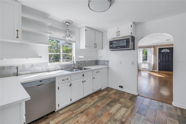 kitchen featuring a wealth of natural light, white cabinets, dark wood-type flooring, and appliances with stainless steel finishes