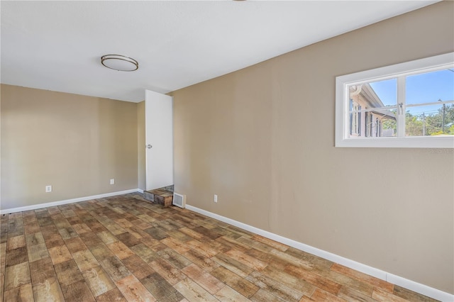 spare room with wood-type flooring