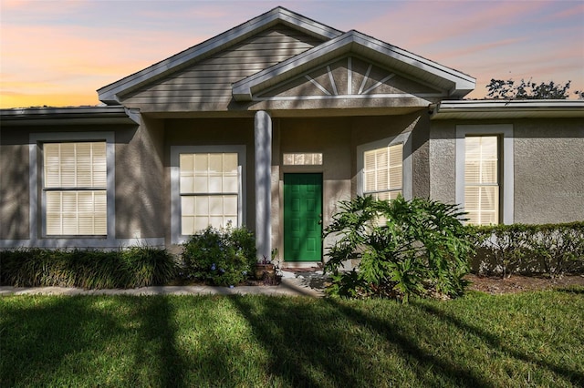 exterior entry at dusk with a yard