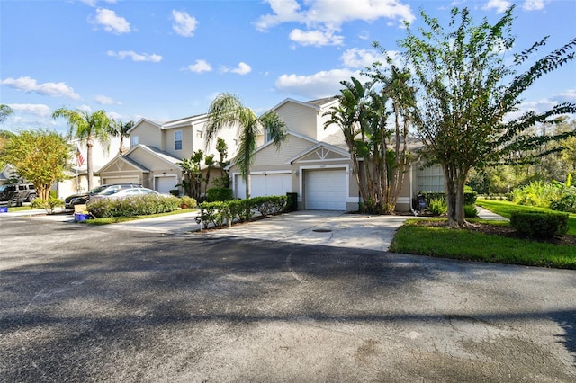 1687 Starling Dr, Tarpon Springs, FL 34689 - view of front facade featuring driveway, a residential view, a garage, and stucco siding