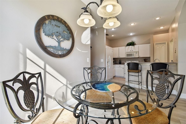 1687 Starling Dr, Tarpon Springs, FL 34689 - dining space featuring light wood-style flooring, baseboards, and recessed lighting