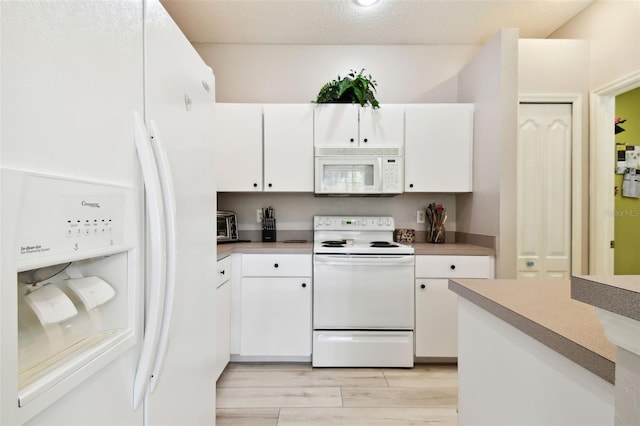 kitchen with a textured ceiling, white cabinetry, light hardwood / wood-style flooring, and white appliances